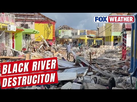 Trudging through rubble amid devastation from Hurricane Melissa in Black River, Jamaica.