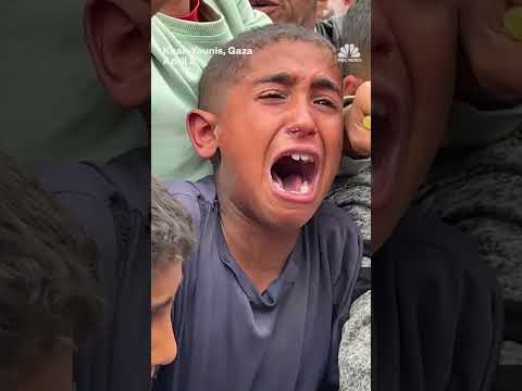 Hungry children struggle for food handouts in Gaza