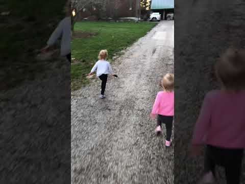 Twin girls running with their grandpa
