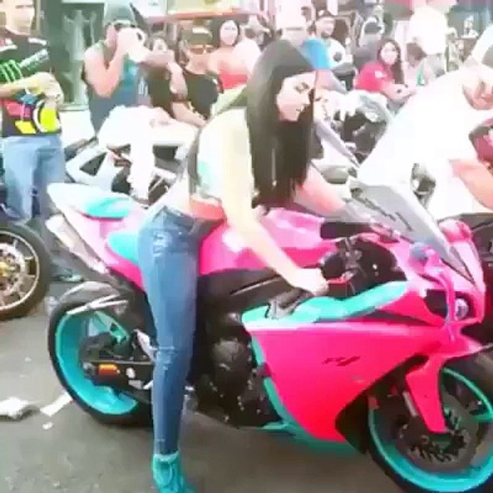 The pretty girl turing the motorbike