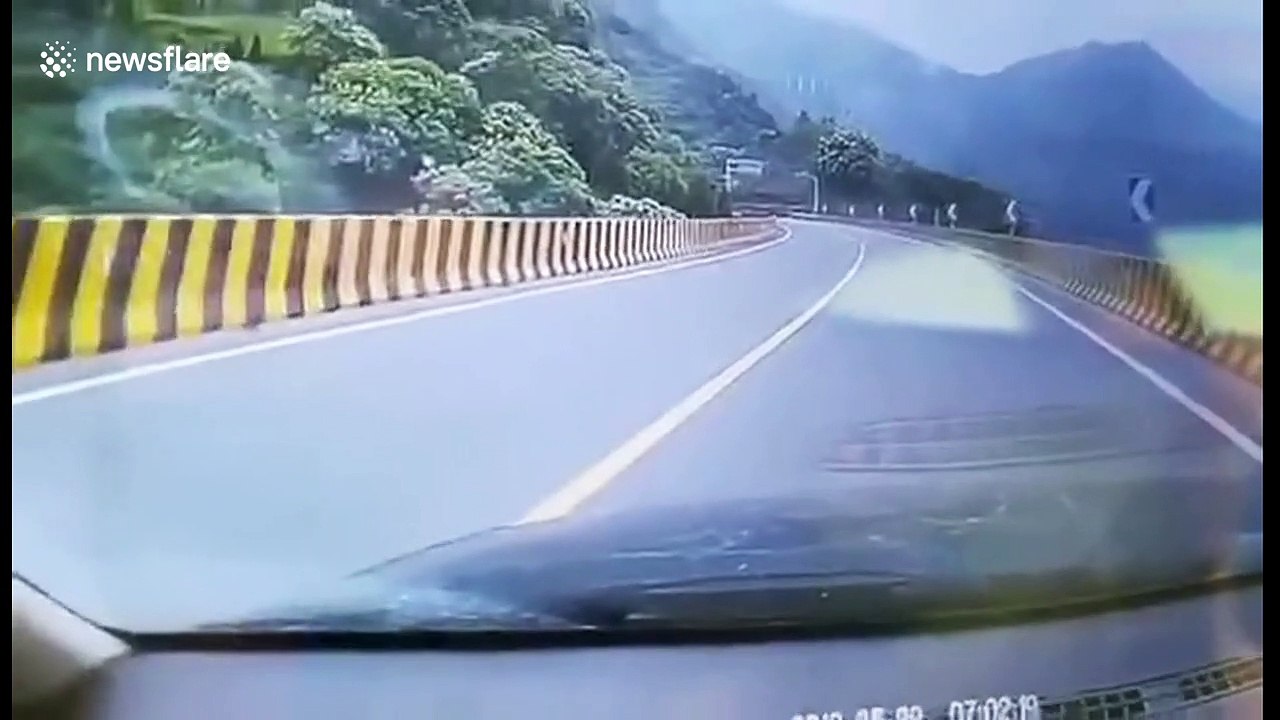 Heroic car driver jumps into driverless lorry to stop it from sliding down Chinese highway