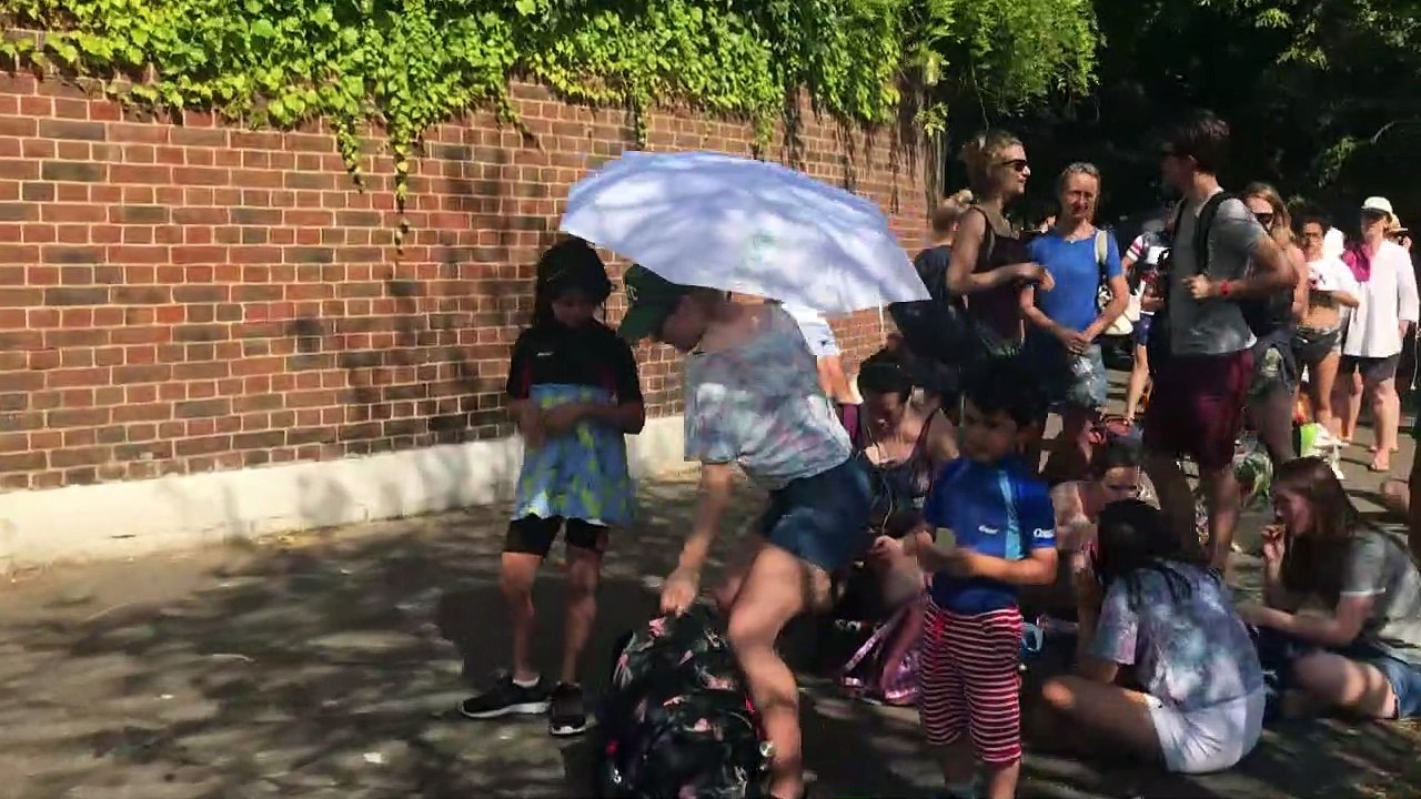 Customers queue for hours in hot weather to get into pool