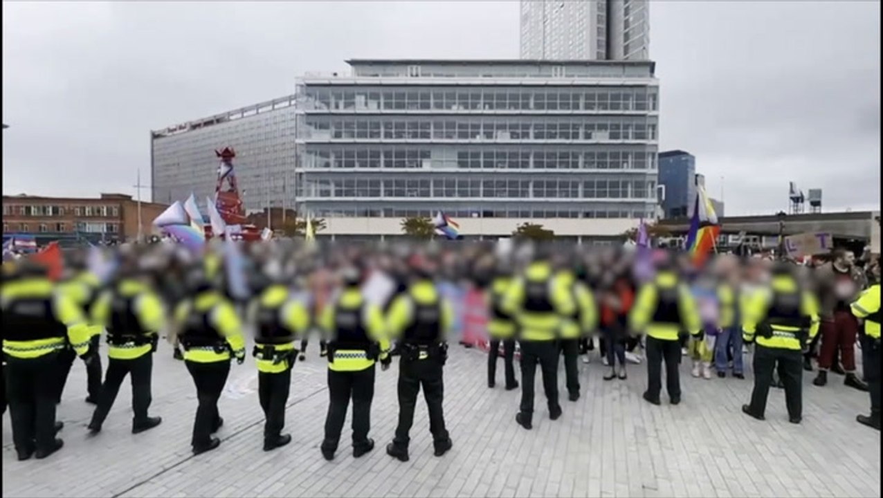 Police form barrier between protesters from both sides of transgender debate in Belfast