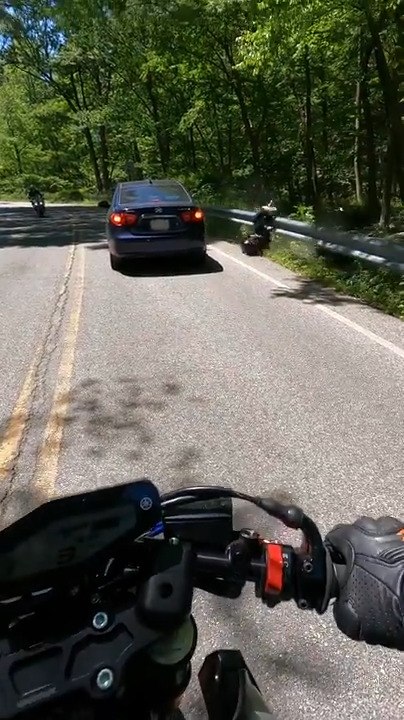 Motorcyclist Nearly Crashes Into Moving Car