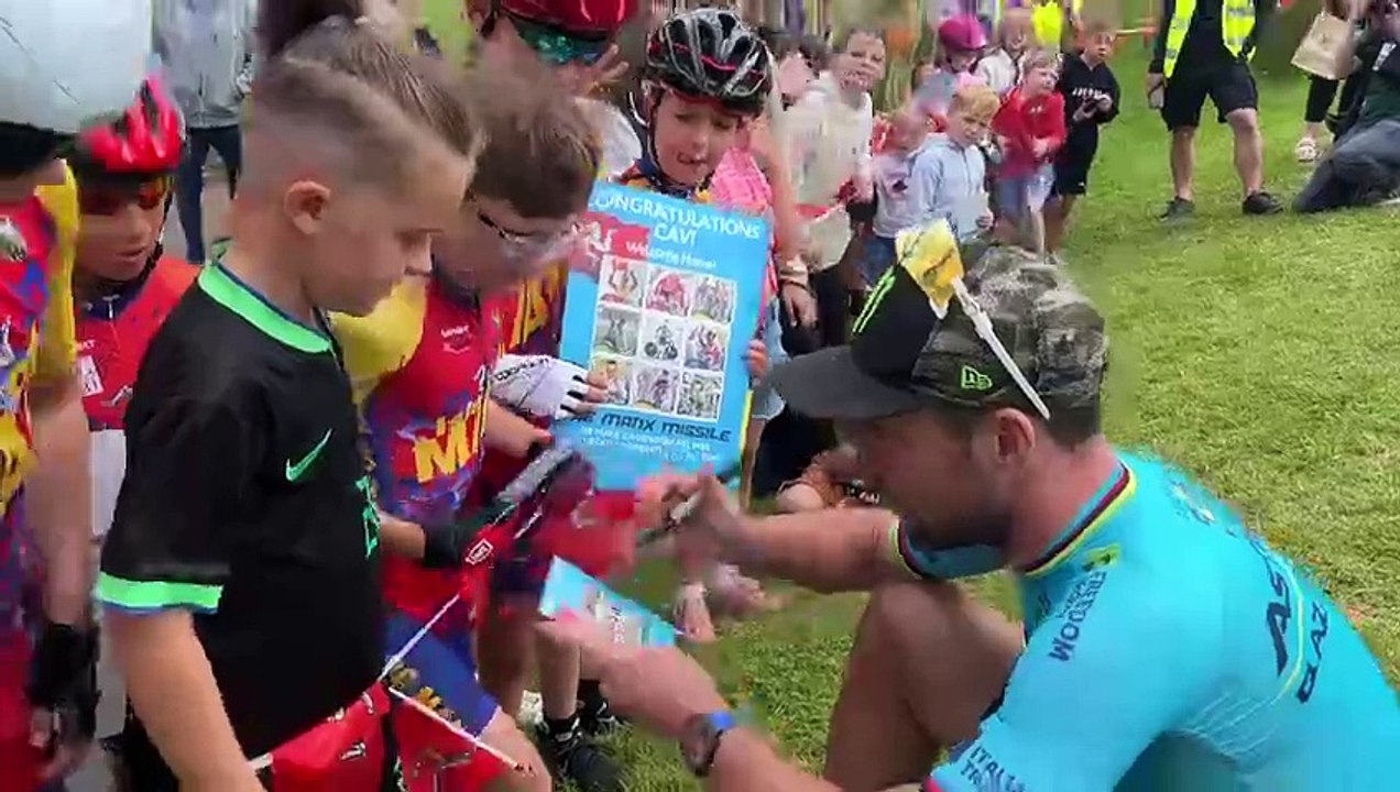 Sir Mark Cavendish signing autographs for children in Douglas
