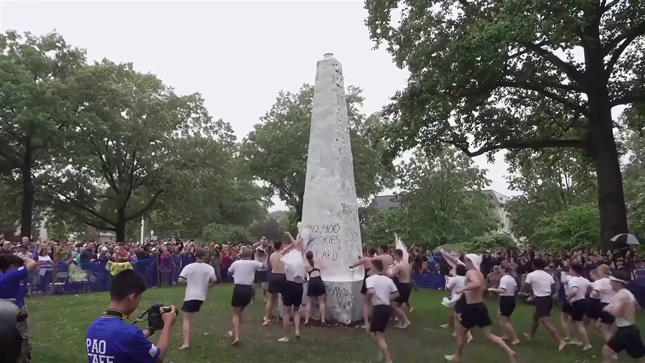 First year U.S. naval students conquer greased obelisk in annual ritual