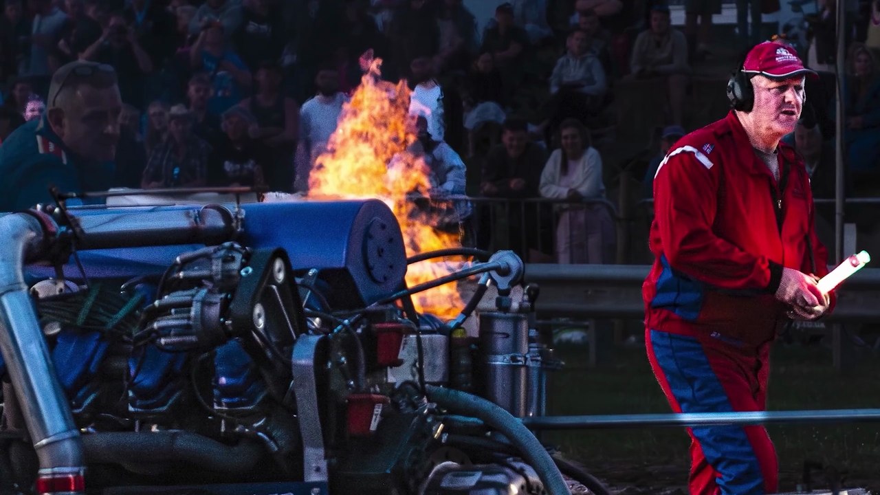 Black skies and flaming engines at tractor pulling event
