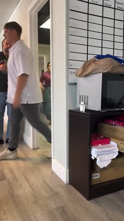 Man Startles Woman Behind Door and Gets Reflexive Hit