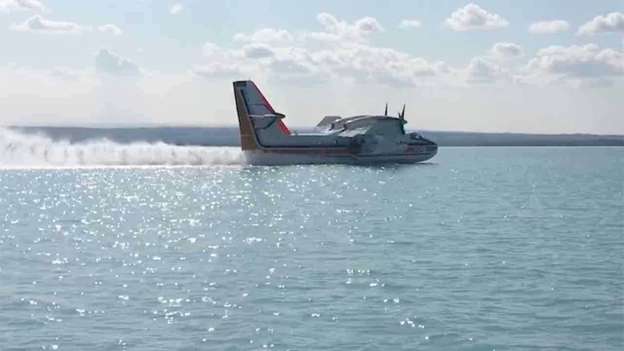 🔥 Firefighting plane skims lake surface before soaring into action!