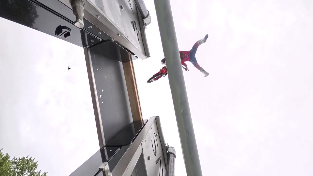 Freestyle motocross rider Ackermann jumps from moving truck to moving truck