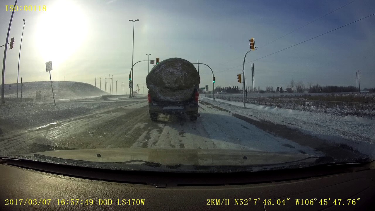 Round Bale Blows Off Truck