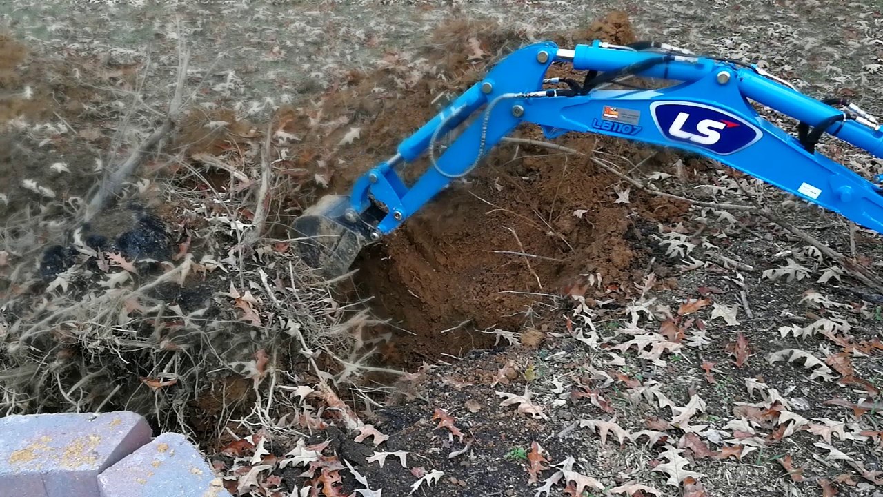 LS MT125 Sub Compact Tractor Burying a Stump