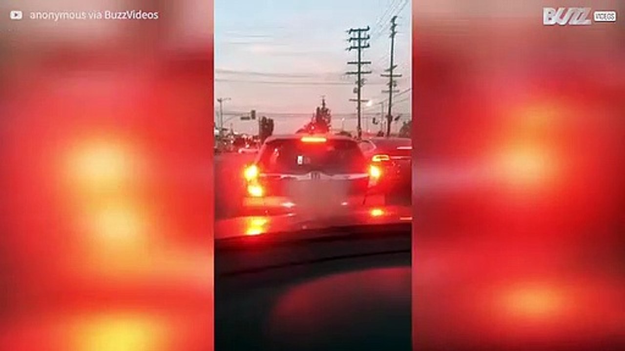 Driver in traffic is seen using Tinder