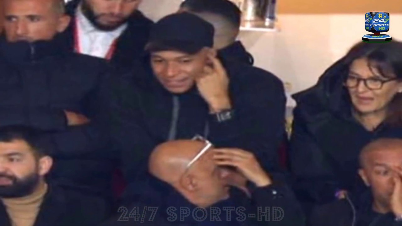Kylian Mbappe watches the second half of PSG's draw at Monaco in the STANDS after being substituted at half-time