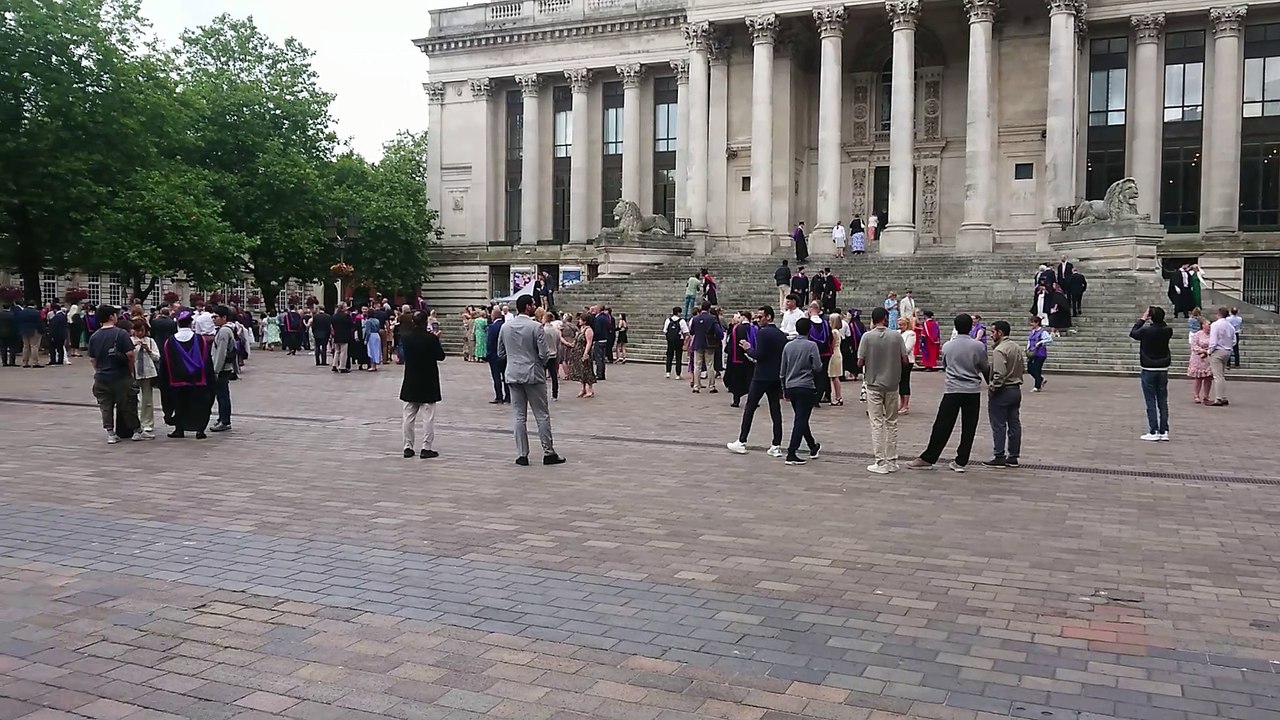 Happy students gather at Guildhall in Portsmouth for graduation ceremonies