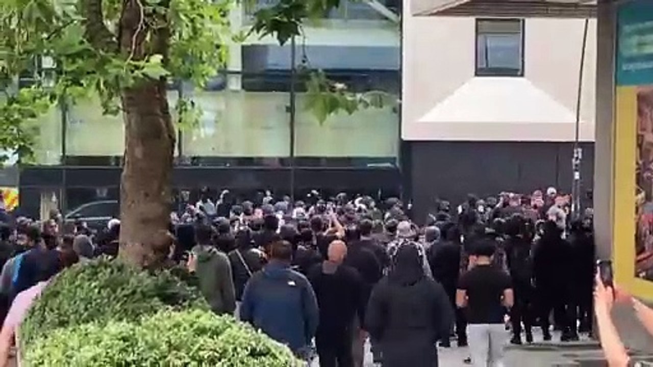 Protestors run through Barker's Pool on August 4