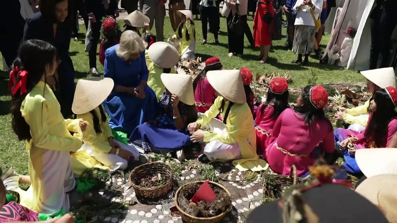 King and Queen flip sausages at barbeque in Sydney