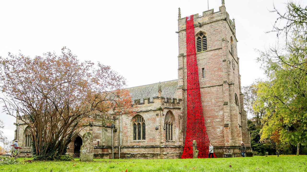 Thousands of knitted poppies cascade from church ahead of Remembrance Day