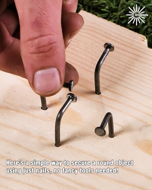 Using just nails to hold a round object in place 🔧