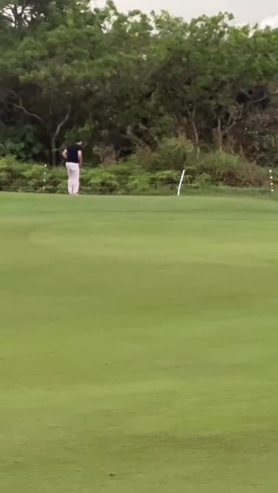 Man Retrieves Friend's Golf Club After It Slips in the Rain