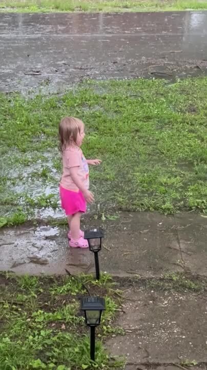 Father and Daughter Create Core Memories While Playing in Rain