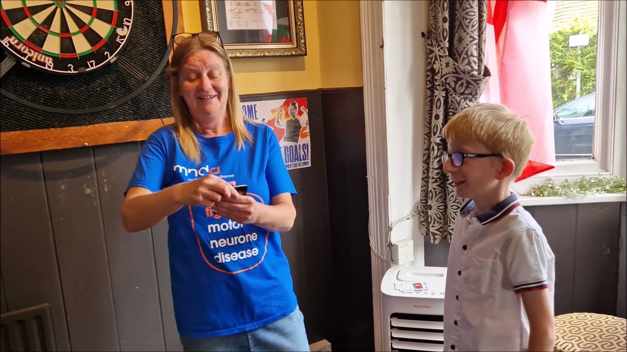 Ten-year-old Worthing boy demonstrates speedy flag recognition skills as he receives a certificate for raising £1,060 for MNDA