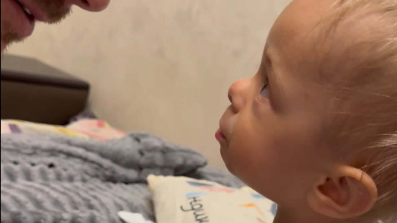 Toddler shares a very serious story with a man in her adorable language