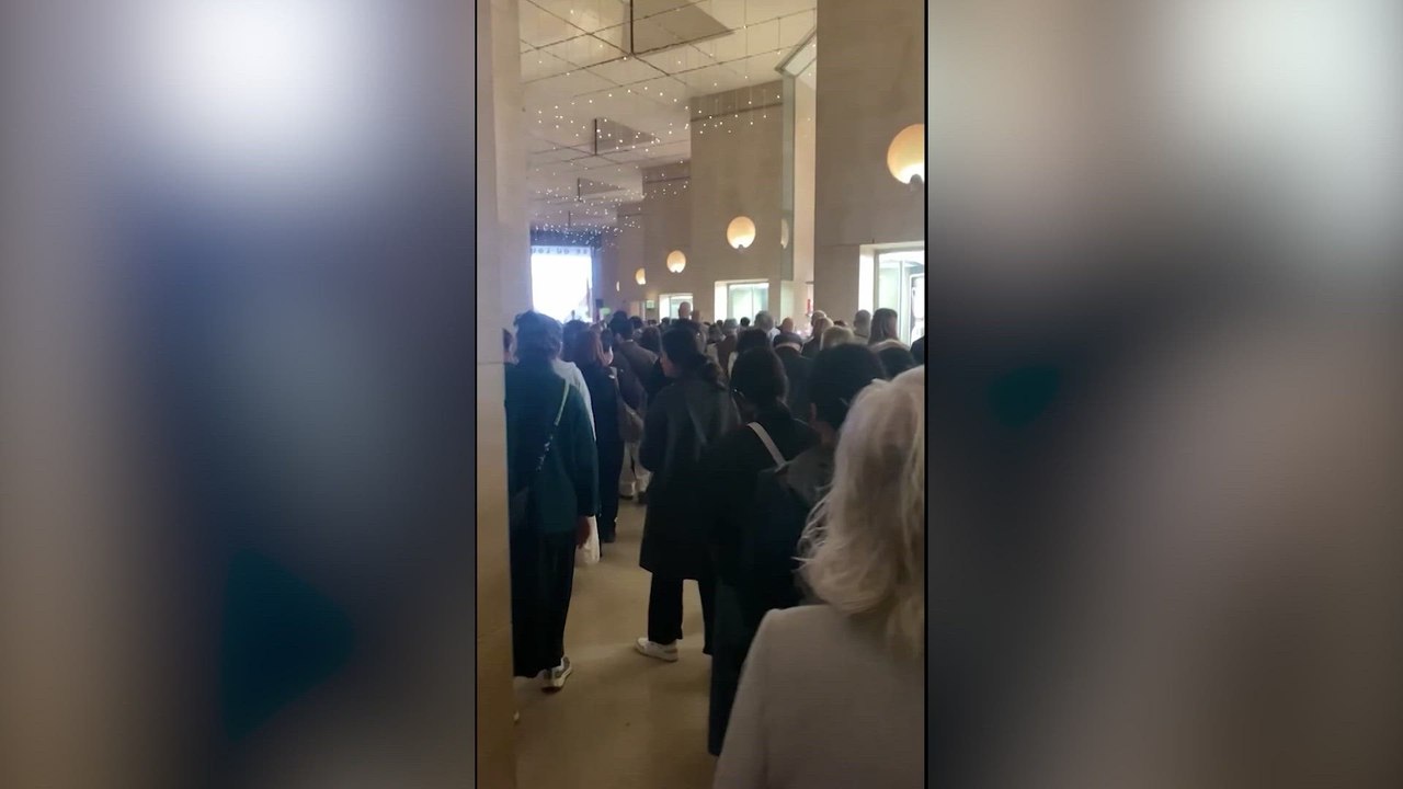Visitors evacuate the Louvre Museum after jewelry theft